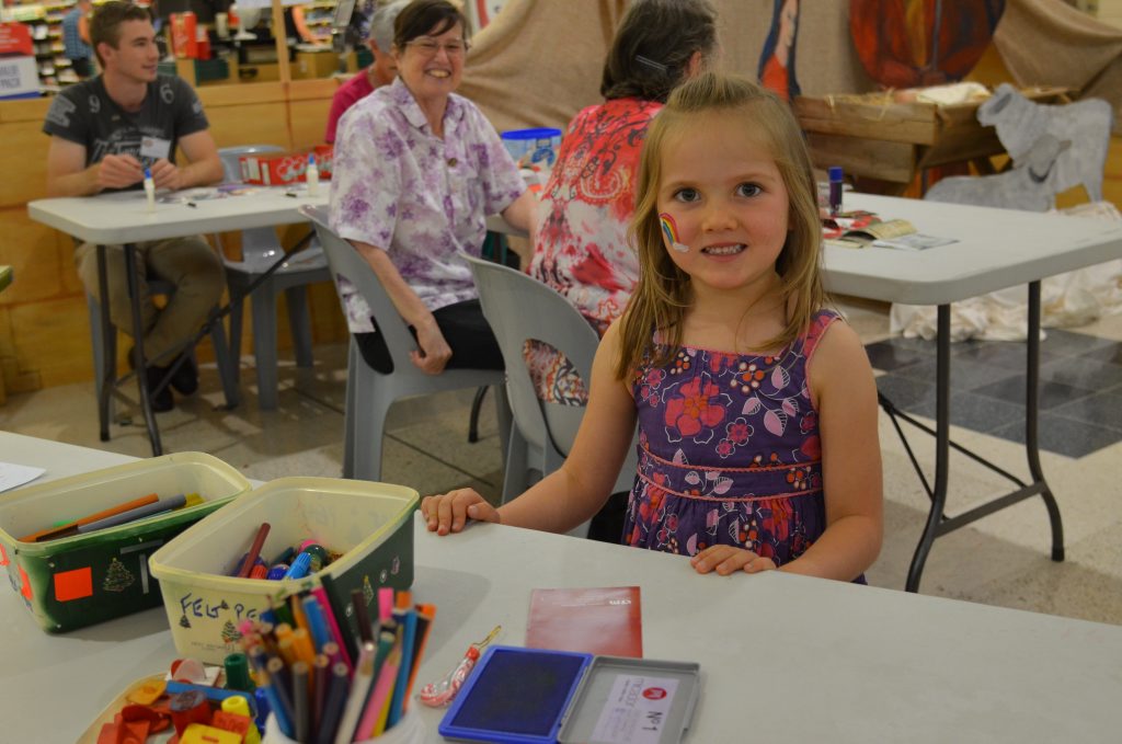 Alyssa Blanch enjoying colouring in and stamping art at Christmas Down Under. 